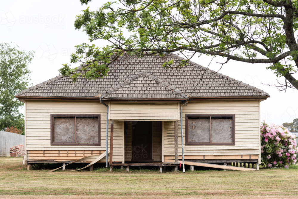 street view of regional suburban 60's style house in need of repair - Australian Stock Image