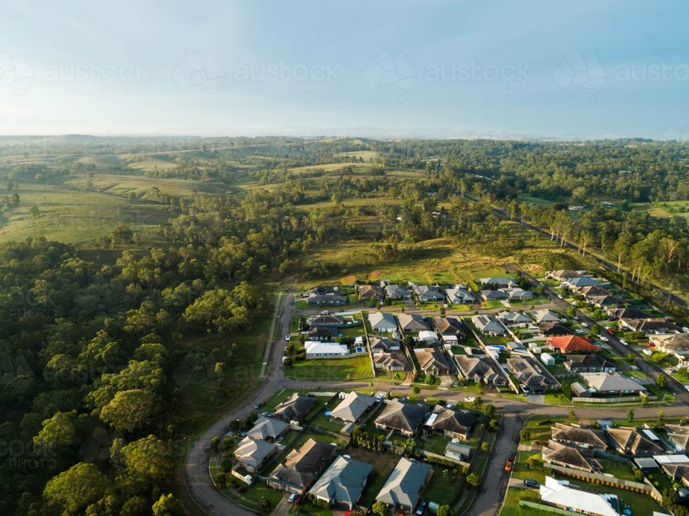 Streets and houses in new suburb at the edge of country town after rain from aerial perspective - Australian Stock Image
