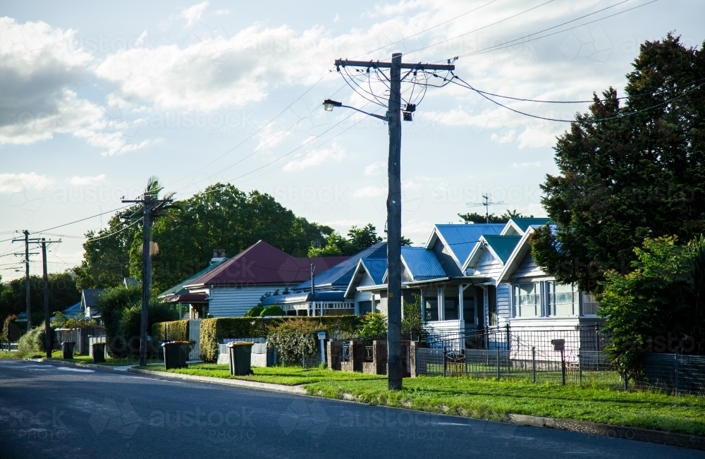 Streetscape of houses on bin day along the road - Australian Stock Image