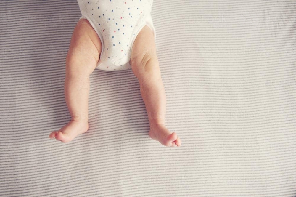 Stretched out baby legs from above - Australian Stock Image