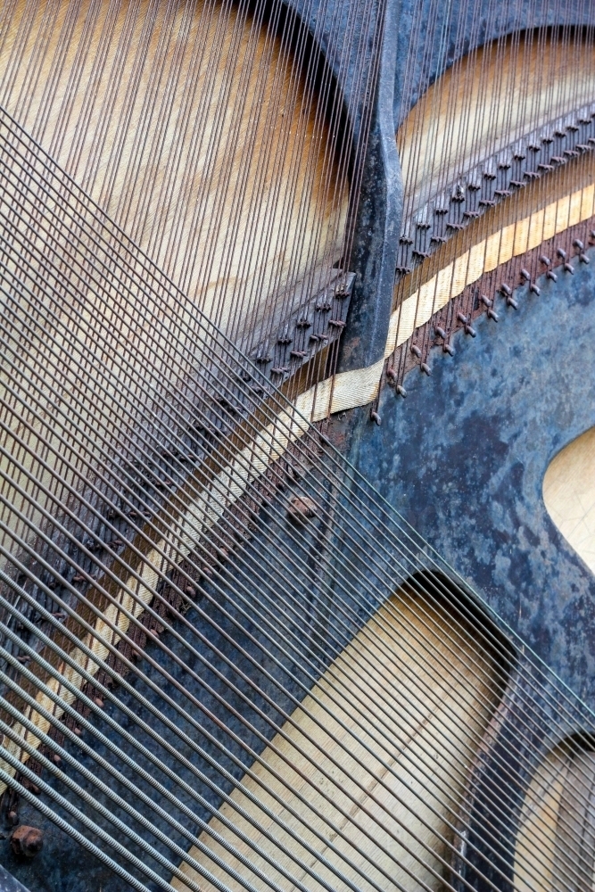Strings crossing on back of piano - Australian Stock Image
