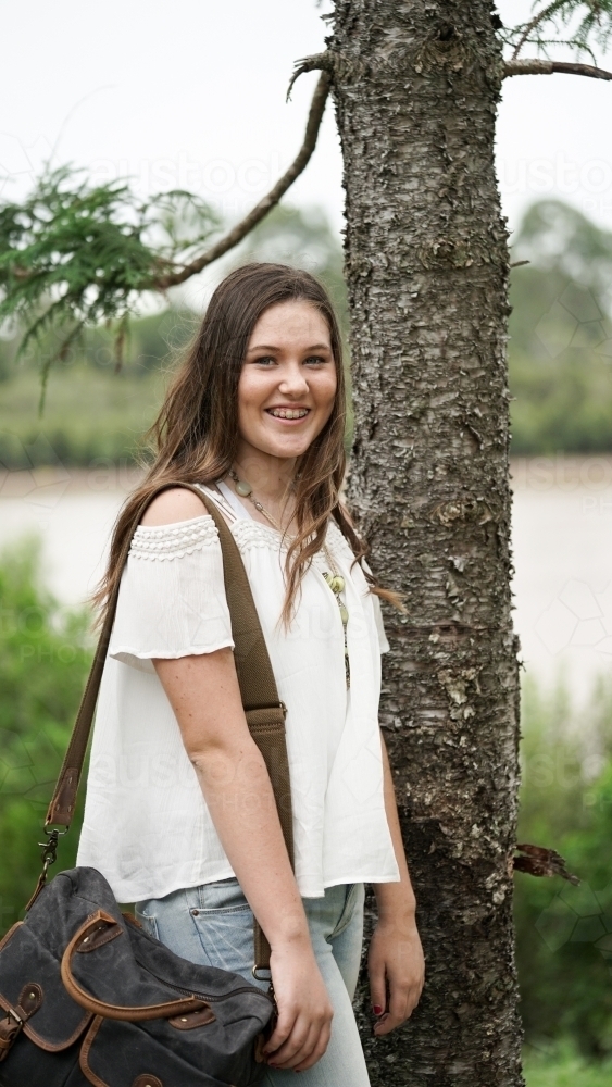 Student with bag in park - Australian Stock Image