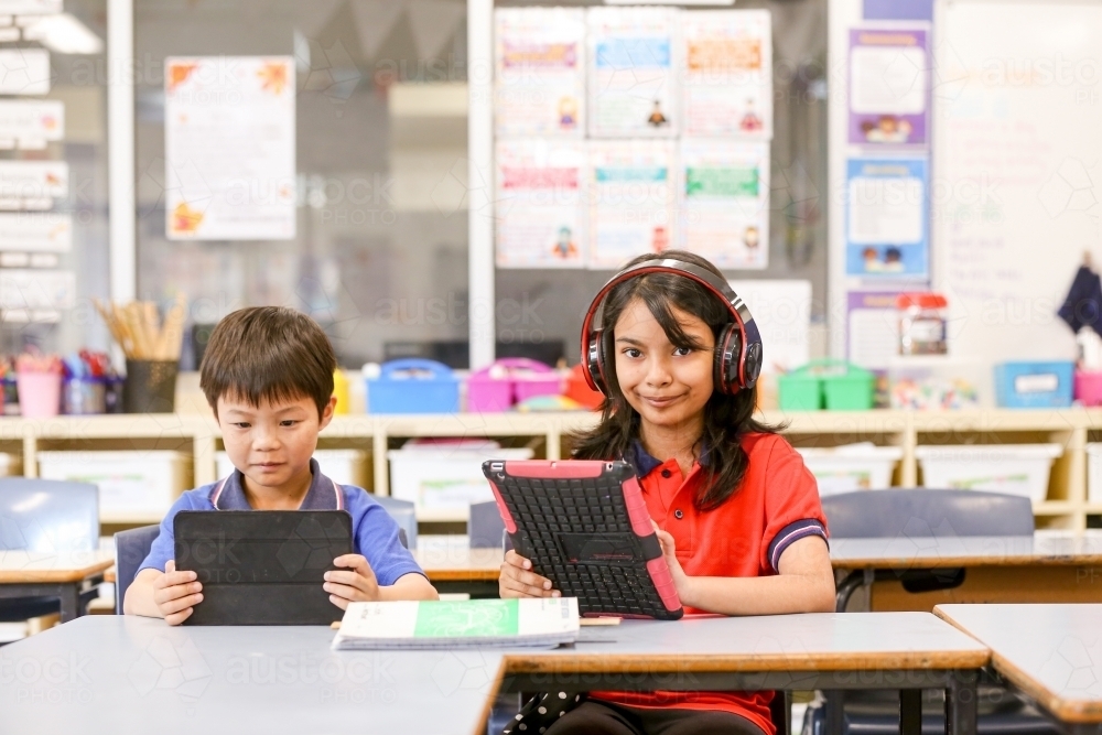 students in the classroom with headphones and iPads - Australian Stock Image