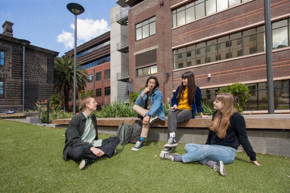 students relaxing on university grounds - Australian Stock Image