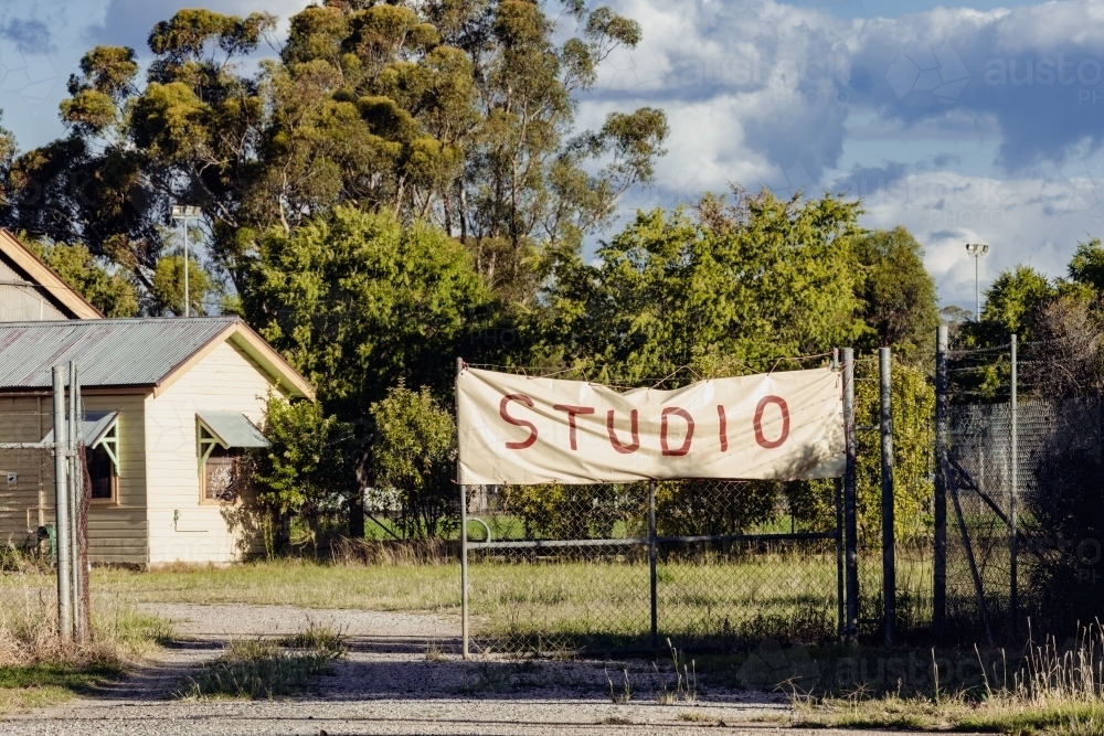 Studio banner displayed on front fence of property - Australian Stock Image