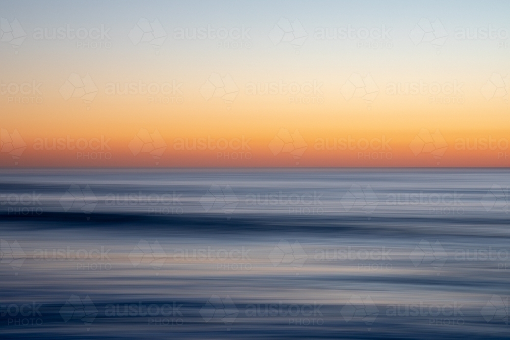 Stunning sunrise over calm ocean - Australian Stock Image