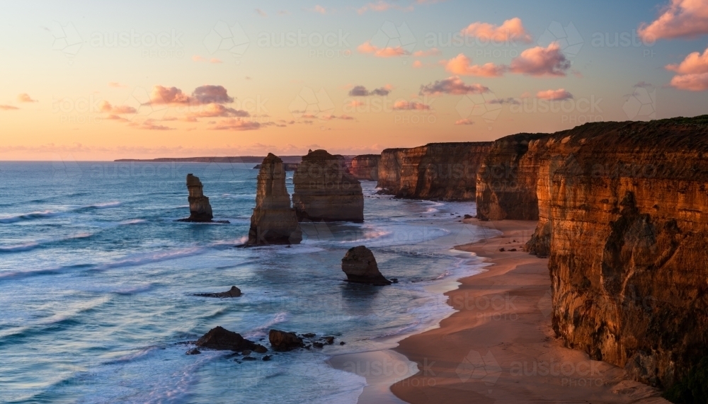 Stunning view of   The Twelve Apostles, with the beautiful sunset colours on  the cliffs - Australian Stock Image