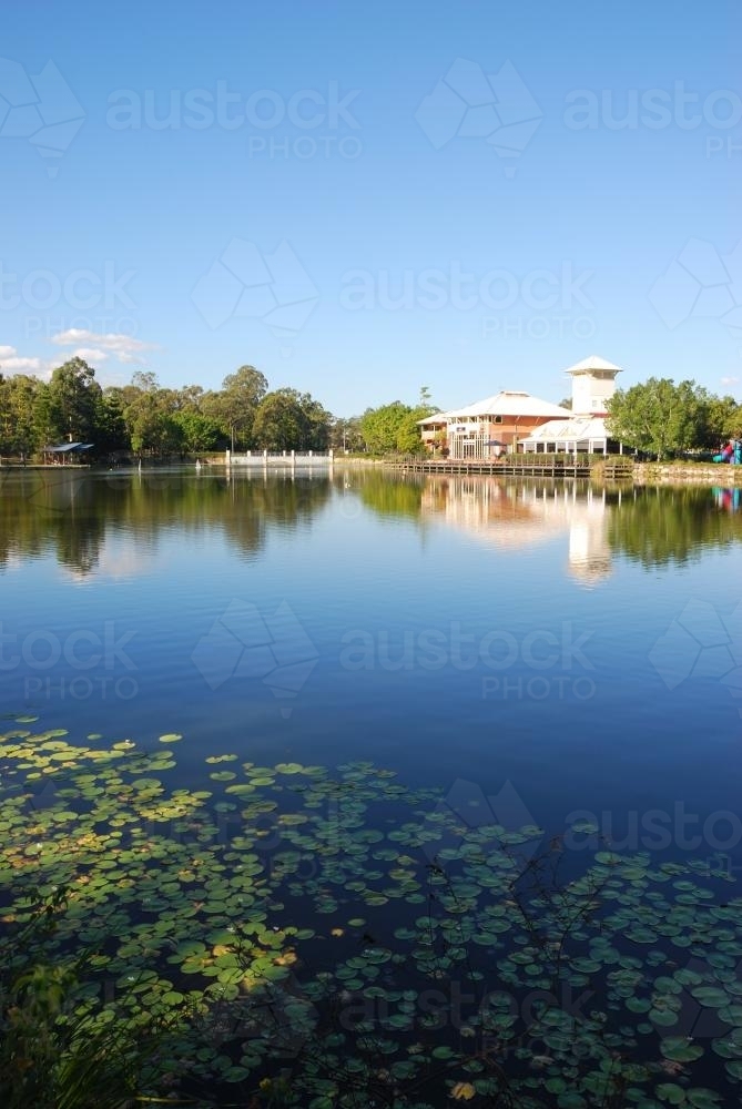 Suburb with shops and cafes by the lake portrait. - Australian Stock Image