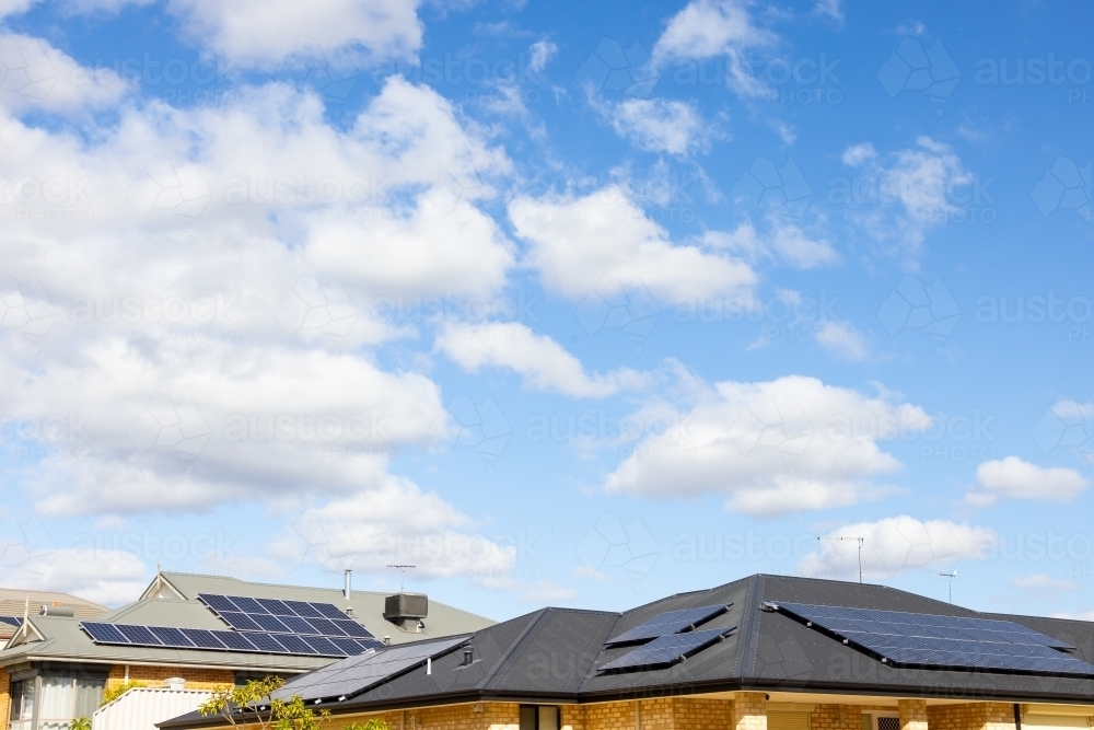 Image of suburban house roofs with photovoltaic solar panels installed ...