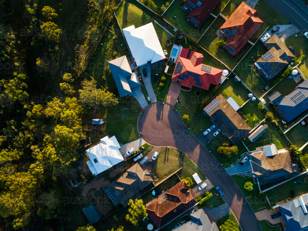 Suburban houses on bin day with bins beside road seen from aerial view - Australian Stock Image