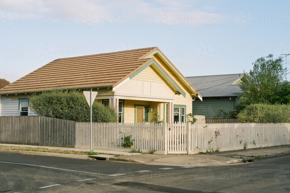 Suburban street corner view of cream house - Australian Stock Image