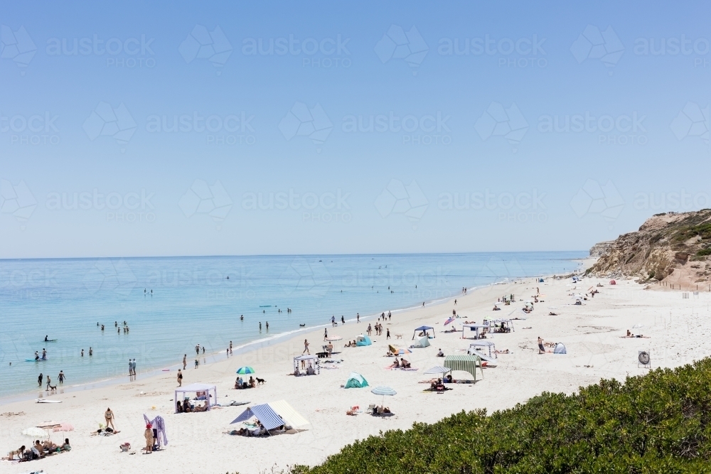 Summer Beach View with crowds of people on white sand - Australian Stock Image