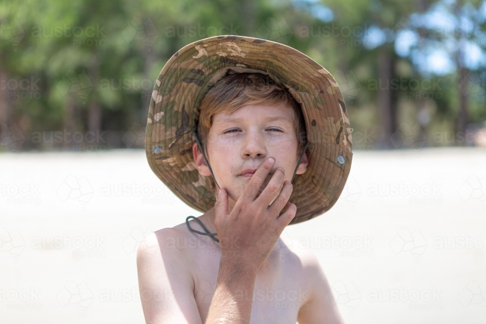 Summer child covered in sand - Australian Stock Image