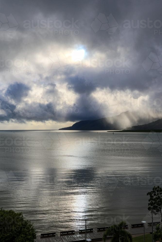 sun breaking through the cloud over the harbour - Australian Stock Image