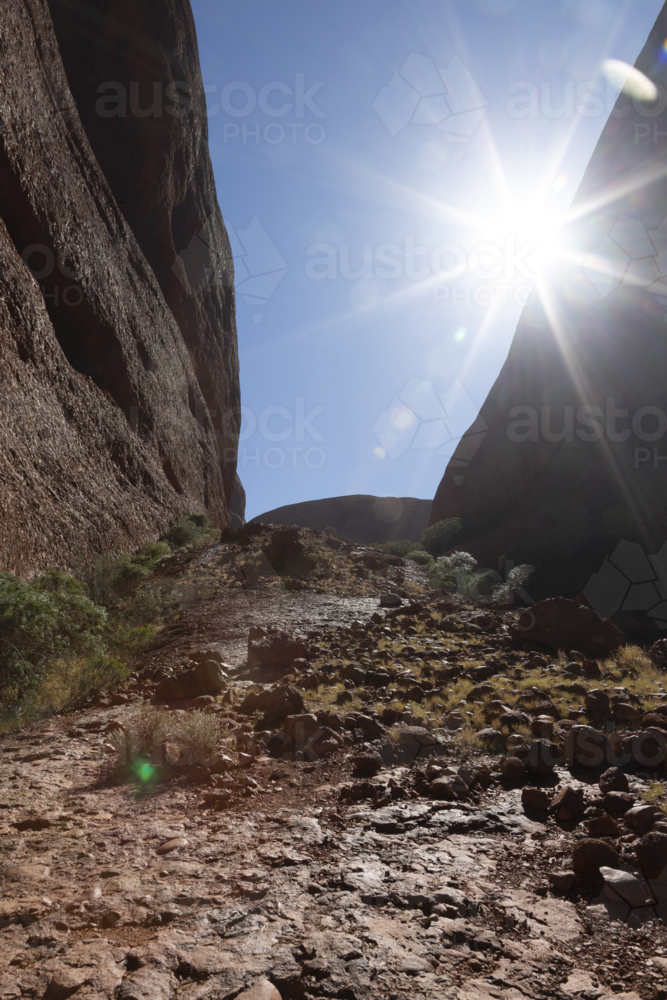 Sun flare between cliffs - Australian Stock Image