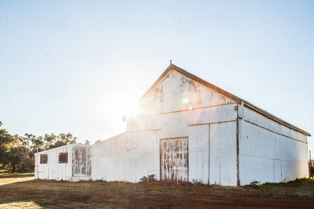 Sun flare over showground pavilion shed in rural country town - Australian Stock Image