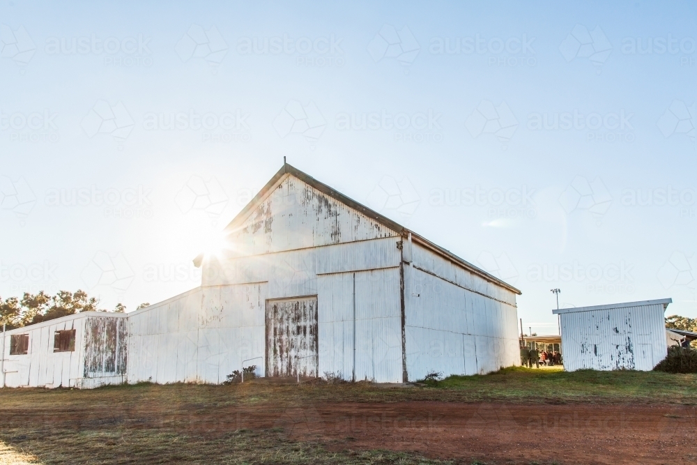 Sun flare over showground pavilion shed in rural country town - Australian Stock Image