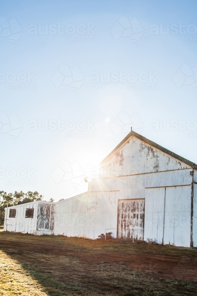 Sun flare over showground pavilion shed in rural country town - Australian Stock Image