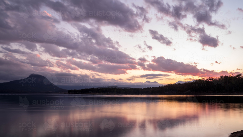 Sun gone down over mountain lake - Australian Stock Image