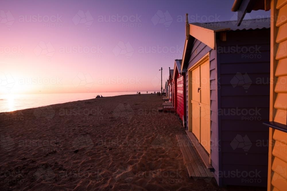 Sun setting on Brighton Bathing Boxes at Dendy Beach - Australian Stock Image