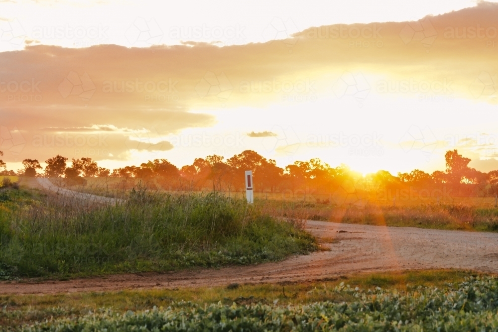 Sun setting on country road in Central Victoria, Australia - Australian Stock Image