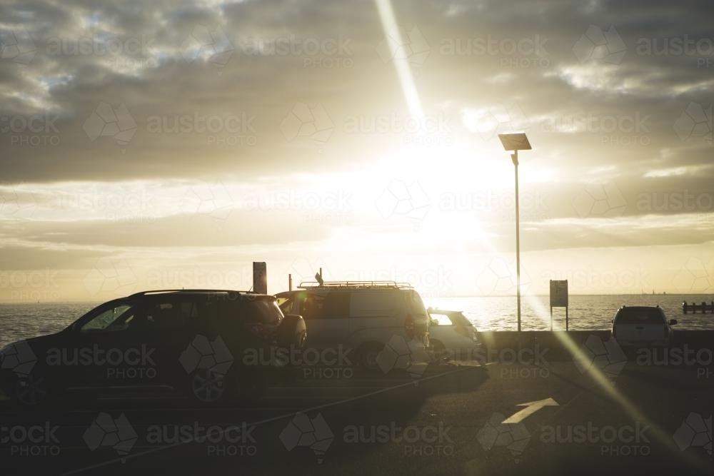 Sun setting over beach carpark - Australian Stock Image