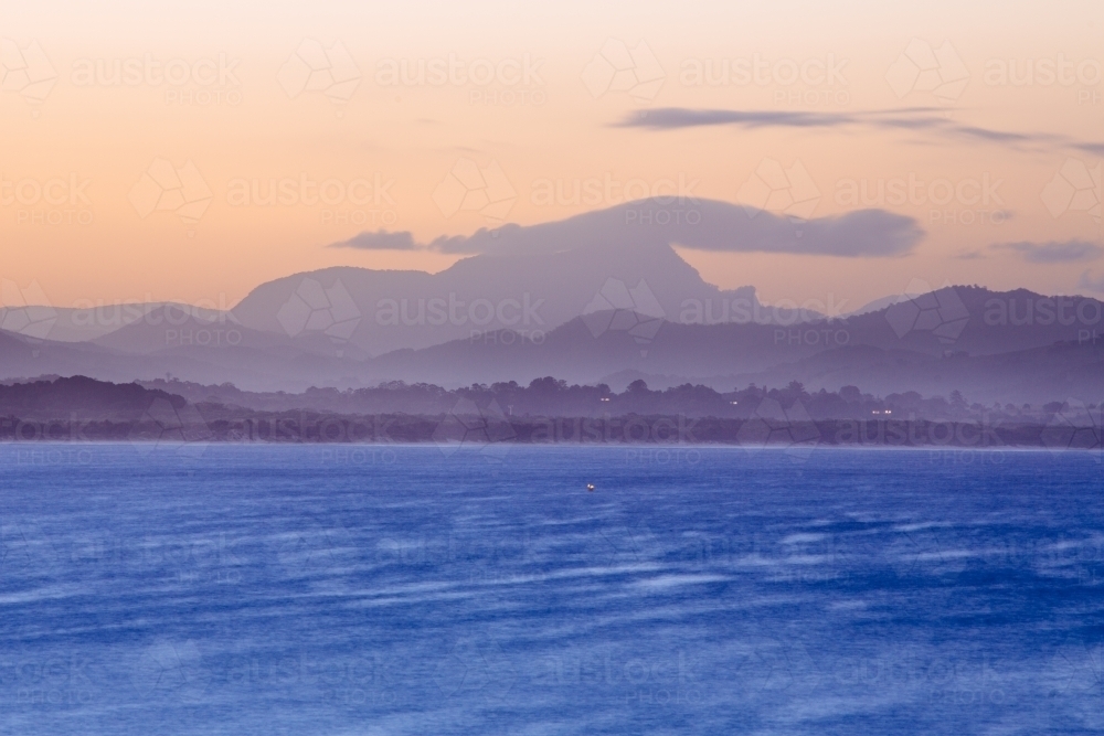 Sun setting over Mt Warning and Byron bay - Australian Stock Image