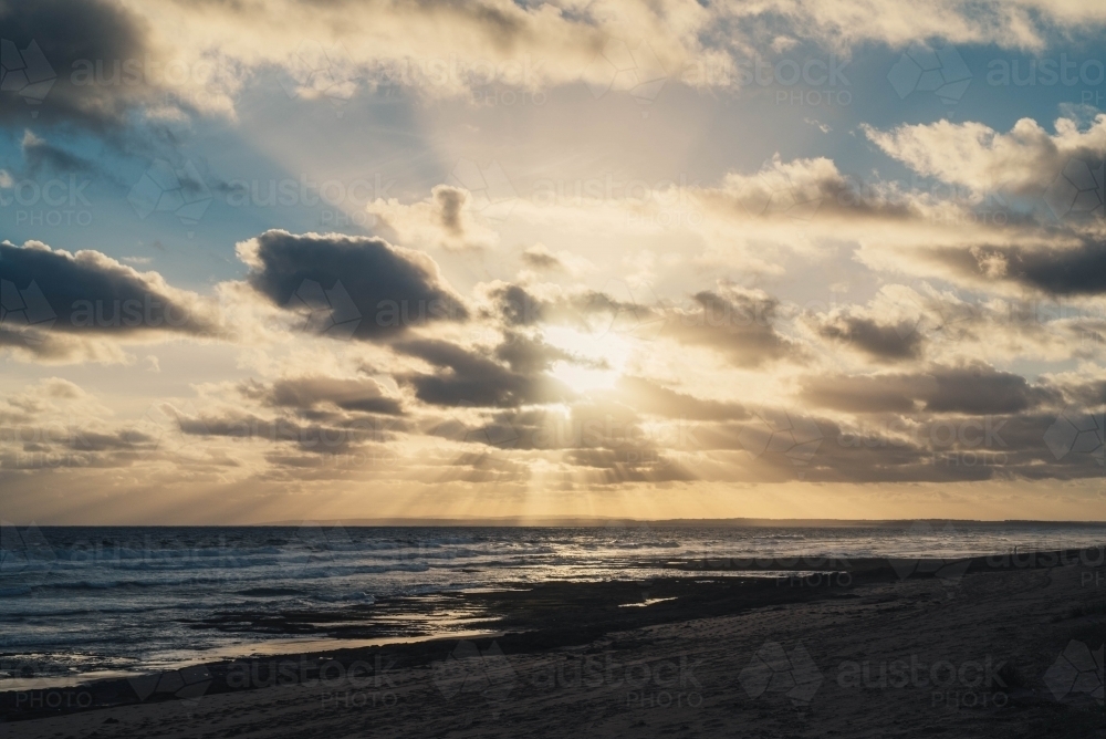 Sun setting over the ocean - Australian Stock Image