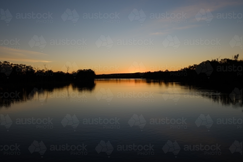 Reflection On Australian Rivers Image of Sun setting over the River Murray in Victoria with calm ...