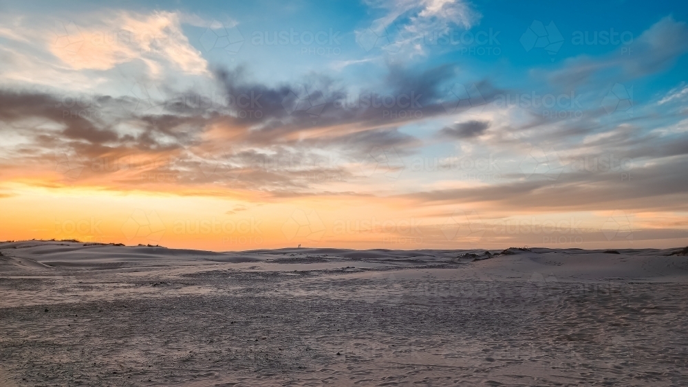 Sun setting over the sand dunes at Birubi Beach at Port Stephens, NSW - Australian Stock Image