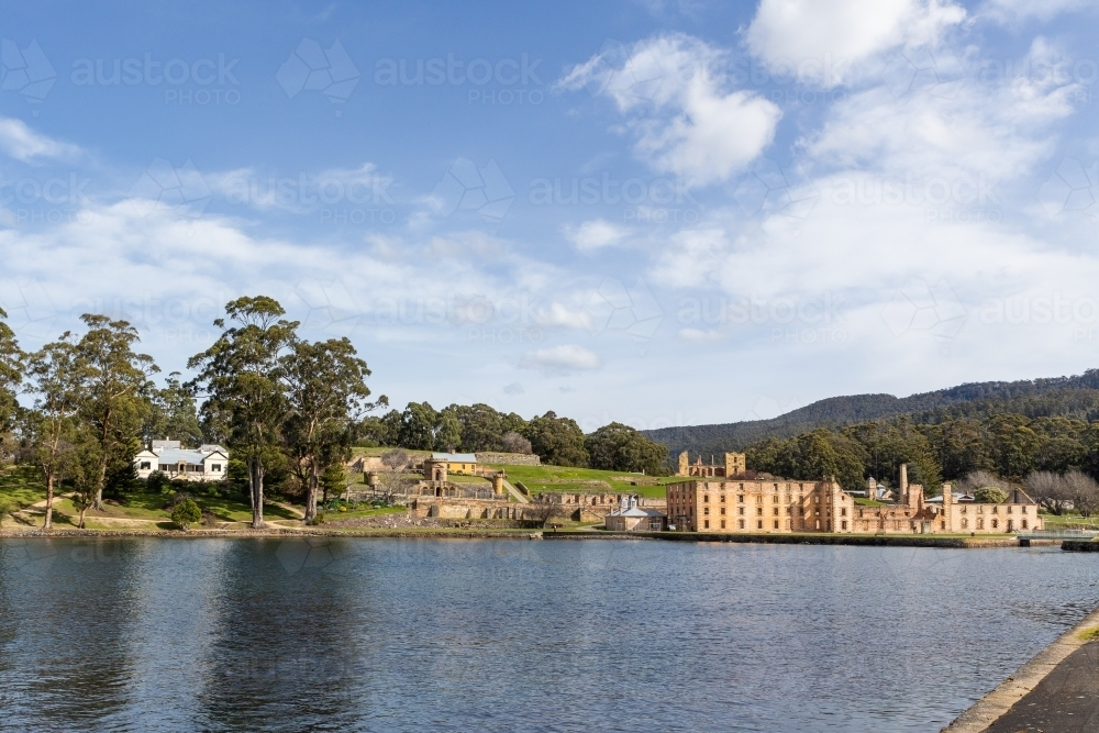 Sun shining brightly over the Penitentiary ruins on the far side of the lake. - Australian Stock Image