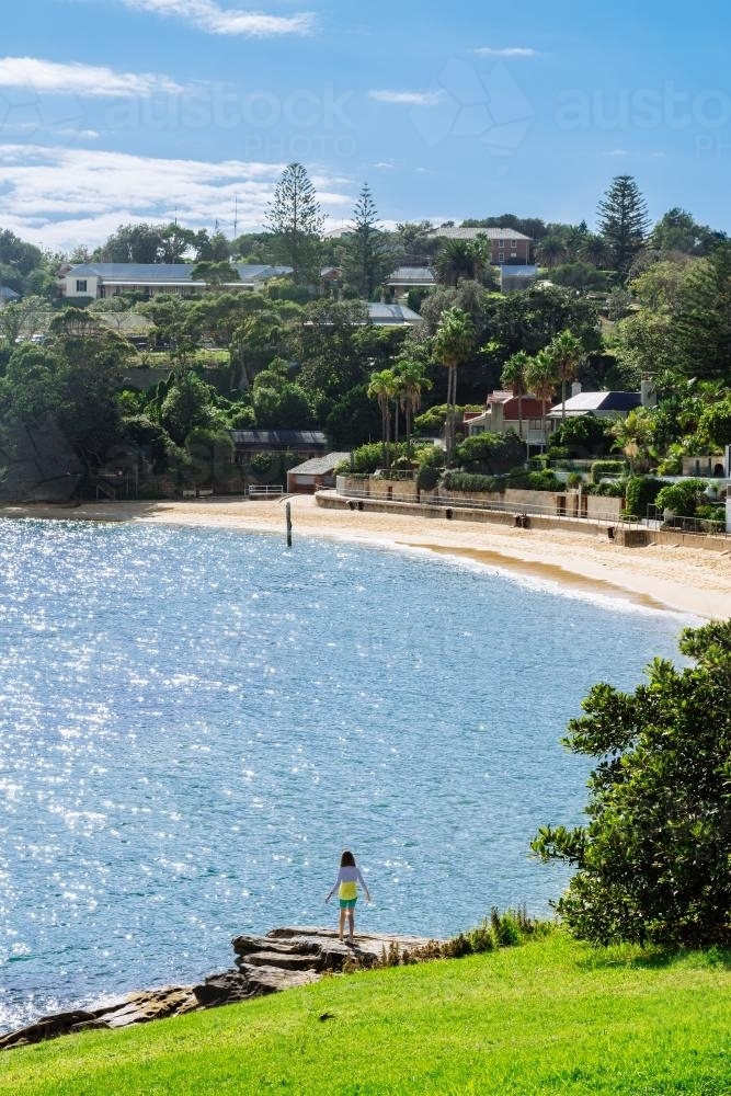 sun sparkling on the water of Camp Cove, one of many tiny, beautiful beaches in Sydney Harbour - Australian Stock Image