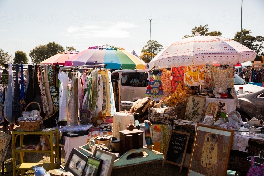 Sunday Markets trash and treasure stall with items for sale under umbrellas - Australian Stock Image