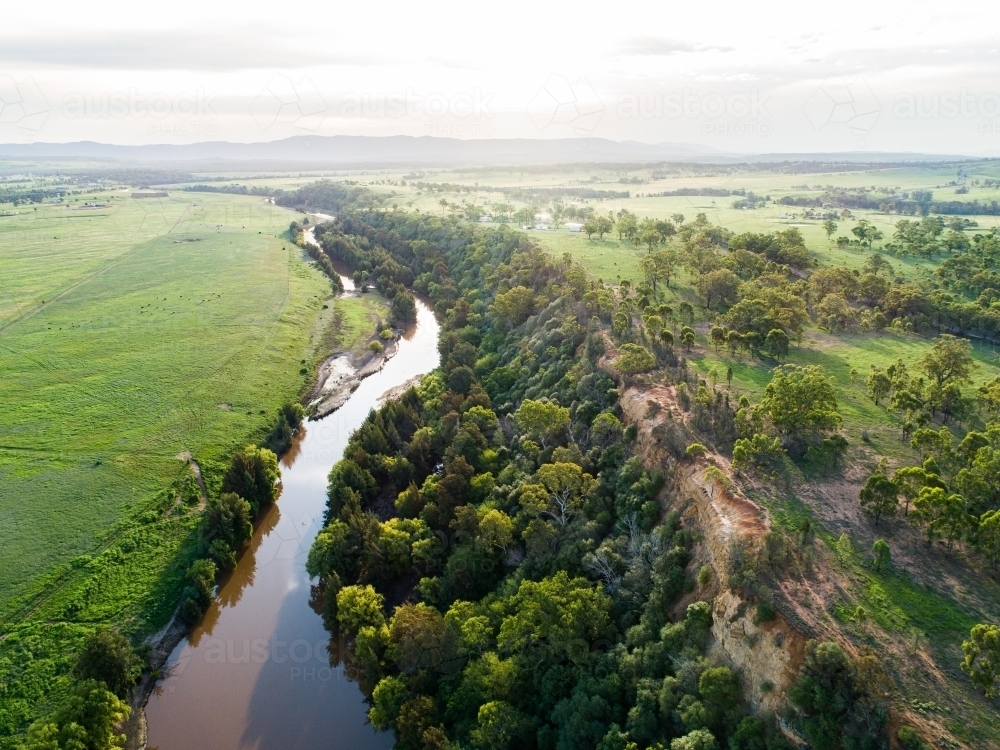 Sunflare light over cliff and Hunter River landscape near Singleton - Australian Stock Image