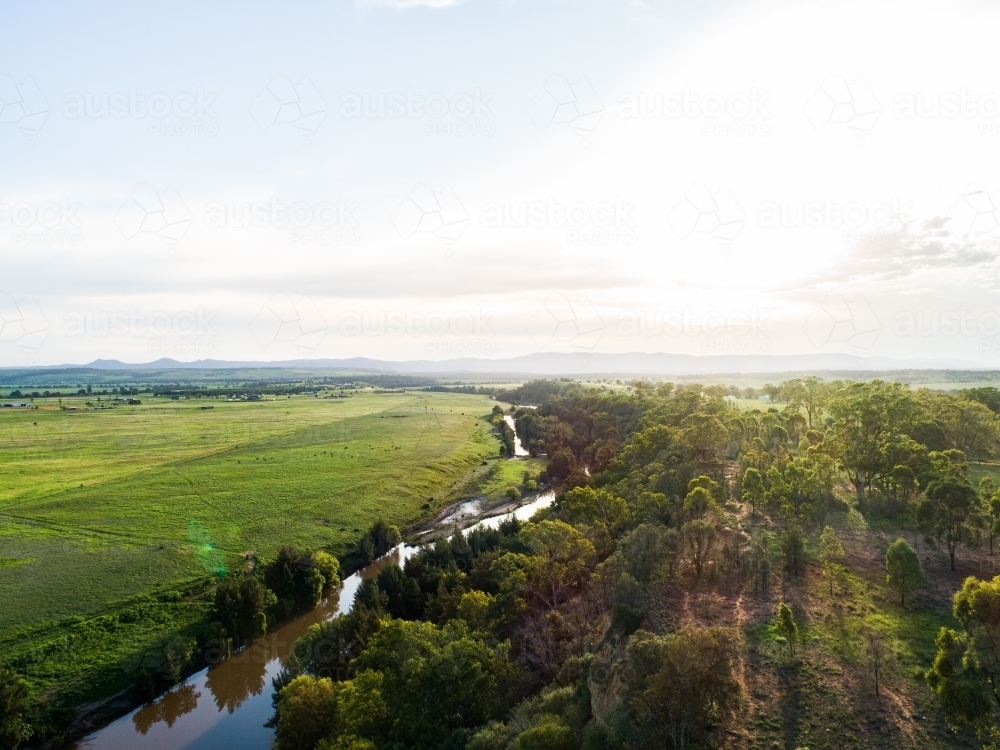 Sunflare light over cliff and Hunter River landscape near Singleton - Australian Stock Image