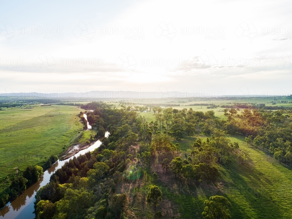 Sunflare light over cliff and Hunter River landscape near Singleton - Australian Stock Image