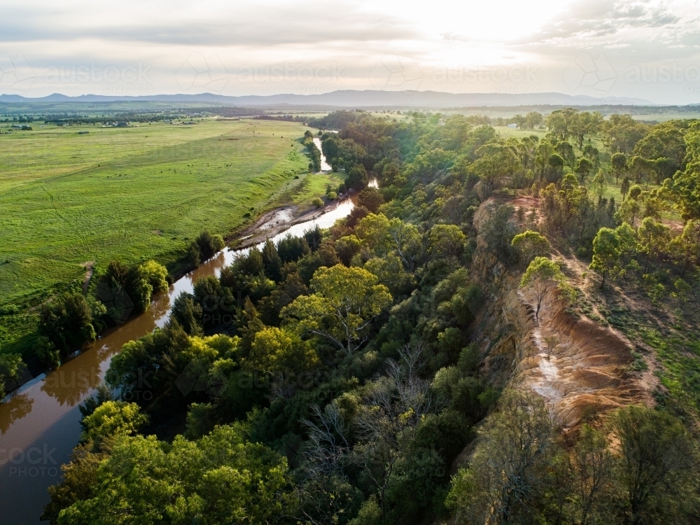 Sunflare light over cliff and Hunter River landscape near Singleton - Australian Stock Image