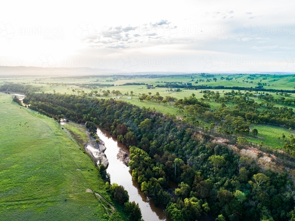 Sunflare light over cliff and Hunter River landscape near Singleton - Australian Stock Image