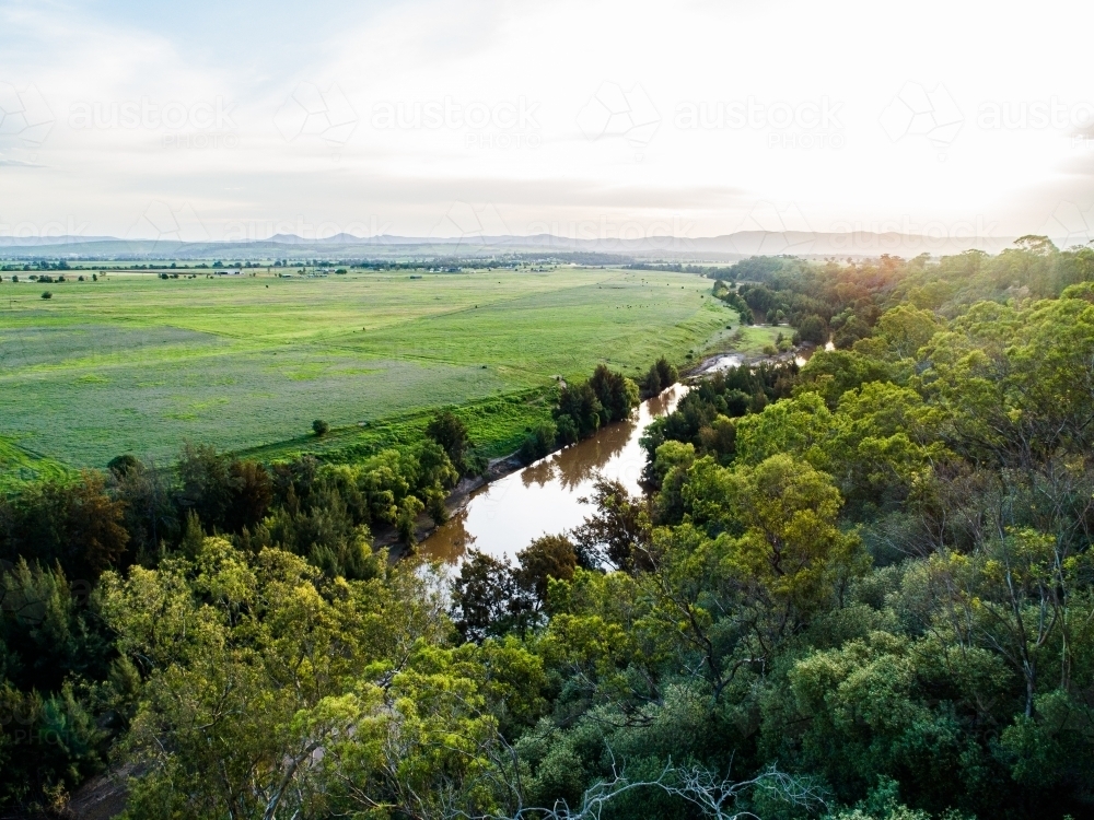 Sunflare light over cliff and Hunter River landscape near Singleton - Australian Stock Image