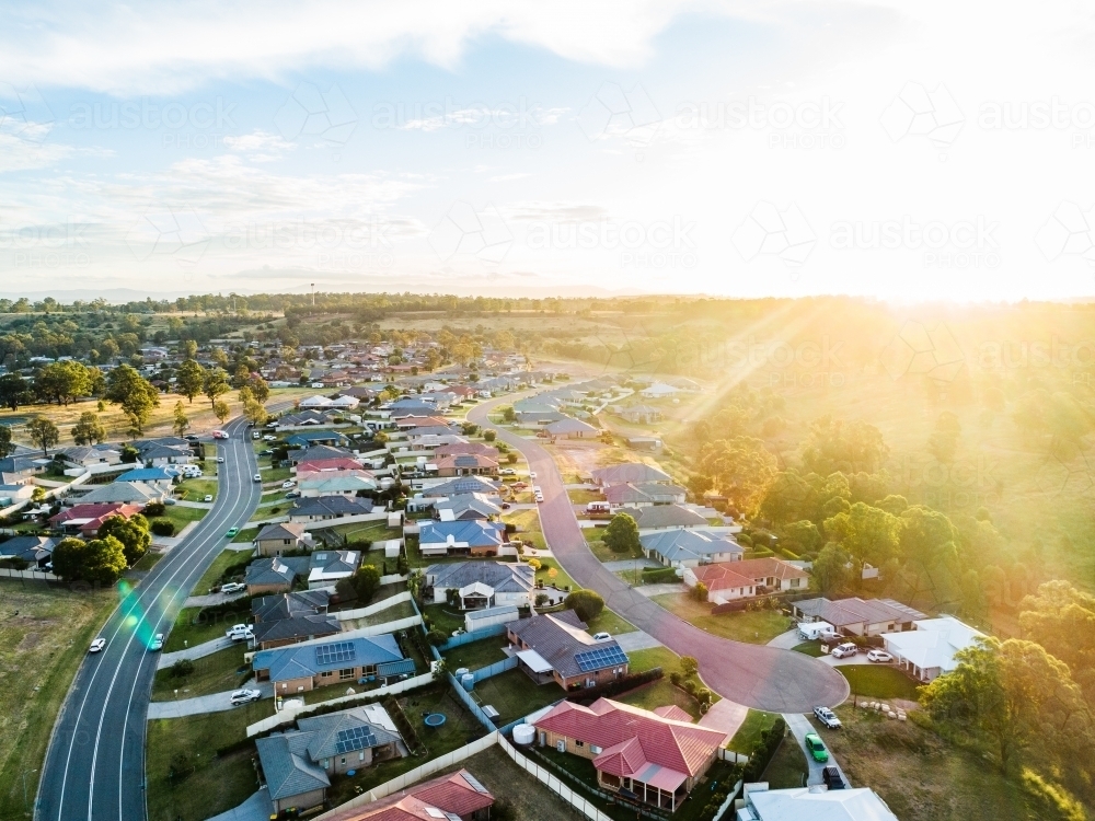 Sunflare of golden light over home owners properties in wealthy part of town - Australian Stock Image