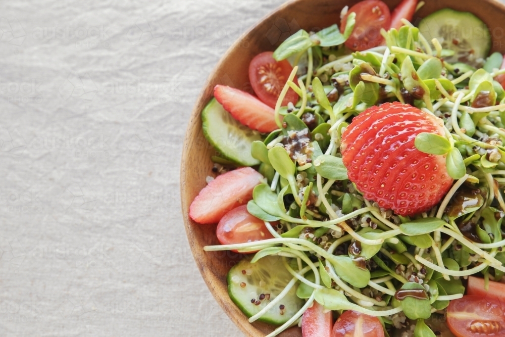 Sunflower sprouts and strawberries salad on wooden bowl : Austockphoto Sunflower sprouts and strawberries salad on wooden bowl - Australian Stock Image