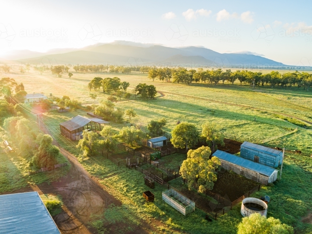 Sunlight over farm sheds and stockyard sun flare and rays - Australian Stock Image