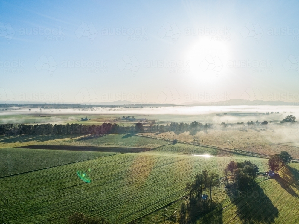 Fram Paddock Image of Sunlight shining off dam in farm paddock with cloud and mist ...