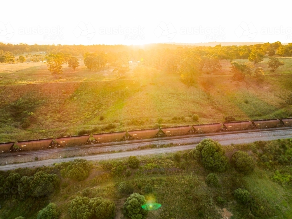 Sunlight shining over coal train - australian exports from Hunter Valley - Australian Stock Image