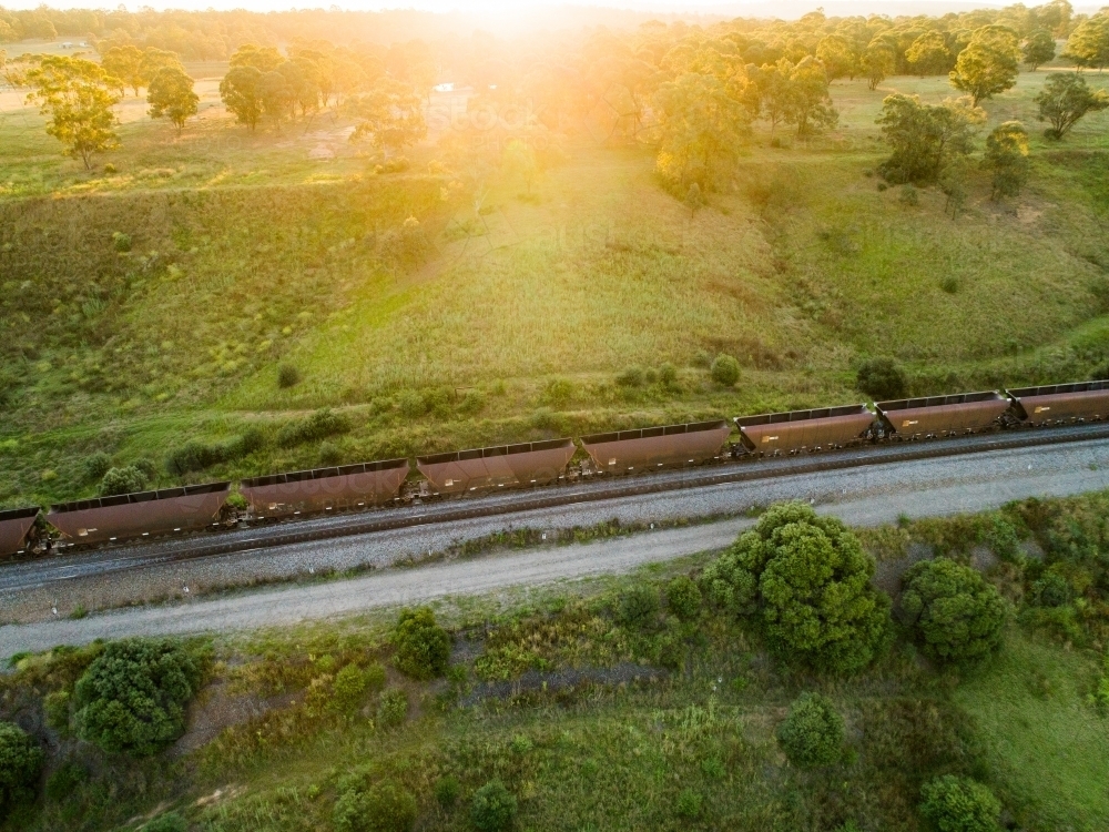 Sunlight shining over coal train - australian exports from Hunter Valley - Australian Stock Image