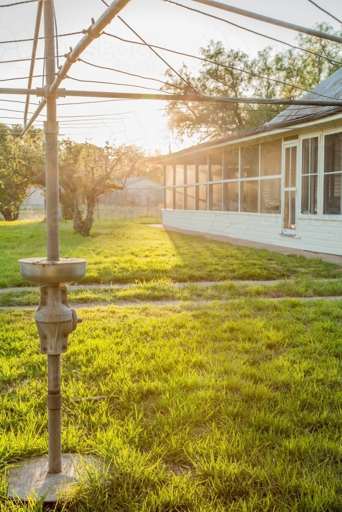 Sunlight shining through clothesline in homestead backyard - Australian Stock Image