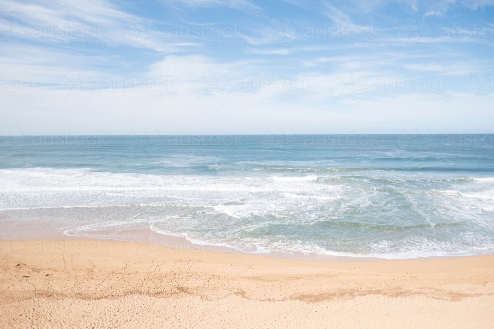Sunlit beach and waves straight on - Australian Stock Image