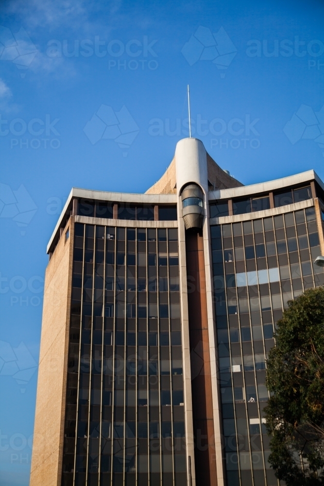Sunlit high rise building in Chatswood Sydney with blue sky - Australian Stock Image