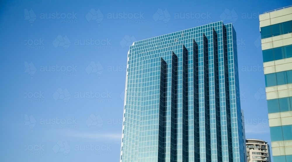 Sunlit high rise building in Chatswood Sydney with blue sky - Australian Stock Image