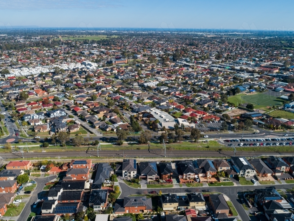 Sunlit Melbourne suburb of Springvale with train track running by houses - Australian Stock Image